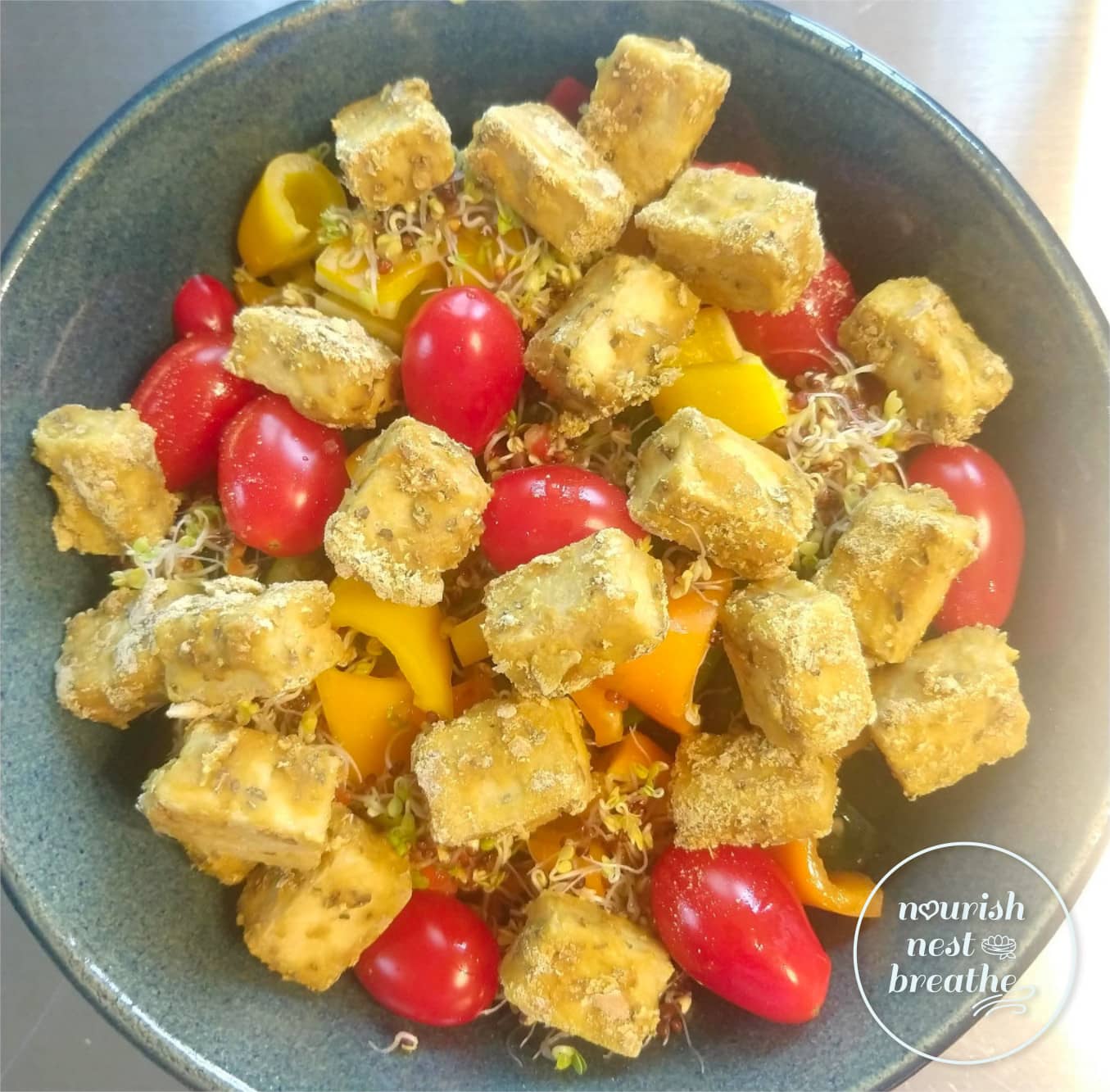 Salad topped with nutritional yeast baked tofu